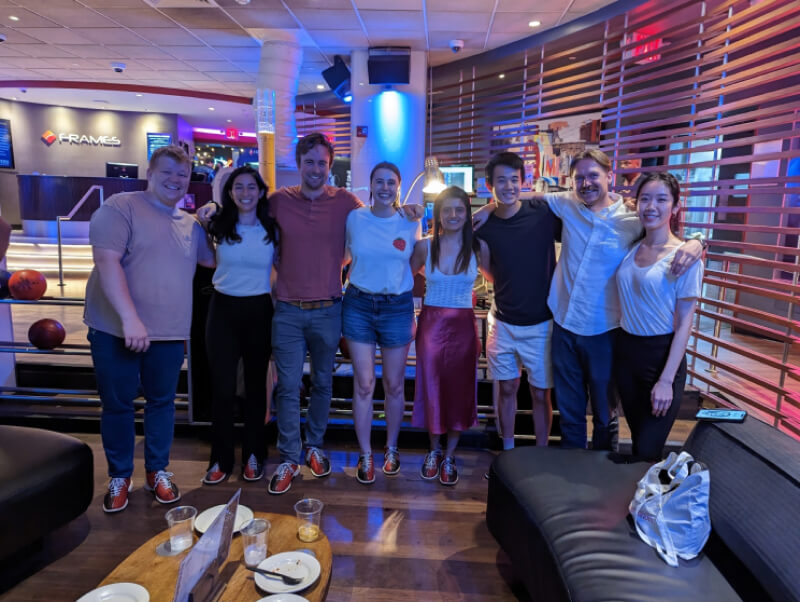 Group of people smiling in front of a camera